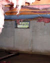 Georgia and South Carolina crawl space with vents, showing mold, rot, and fiberglass insulation dripping off the ceiling.