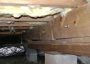 sagging crawl space with wooden shimming a Saint Simons Island crawl space