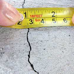 A crack in a poured concrete wall that's showing a normal crack during curing in Metter