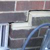 A closeup of a failed tuckpointing job where the brick cracked on a Bamberg home.