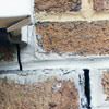 Failed crack repair showing old tuckpointing that cracked on a Warner Robins home.