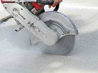 Cutting the driveway for expansion joints during street creep repair in Sylvania