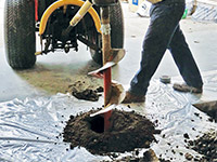 Digging the hole used for wall anchor installation in Glennville.