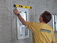 Positioning a wall plate cover on a foundation wall in Hinesville.