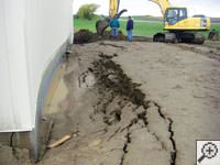 A foundation wall showing severe damage from bowing and buckling in Sylvania