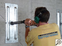 Mounting the steel wall plate for foundation wall repair and straightening in Glennville.