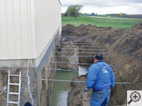 Drilling the hole in the foundation wall for street creep repairs in Guyton