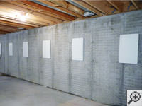 Wall anchor covers installed along a foundation wall that has been straightened in Bamberg.