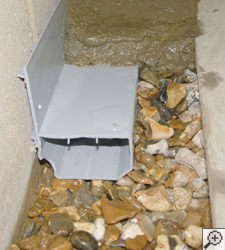 A no-clog basement french drain system installed in Walterboro