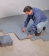 Contractors installing basement sub floor tiles and matting on a concrete basement floor in Hilton Head Island, Georgia and South Carolina