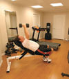 a basement gym and workout room with a wood laminate flooring, installed in Statesboro, GA and SC
